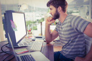 42591846 Casual Young Businessman Looking Computer In Office